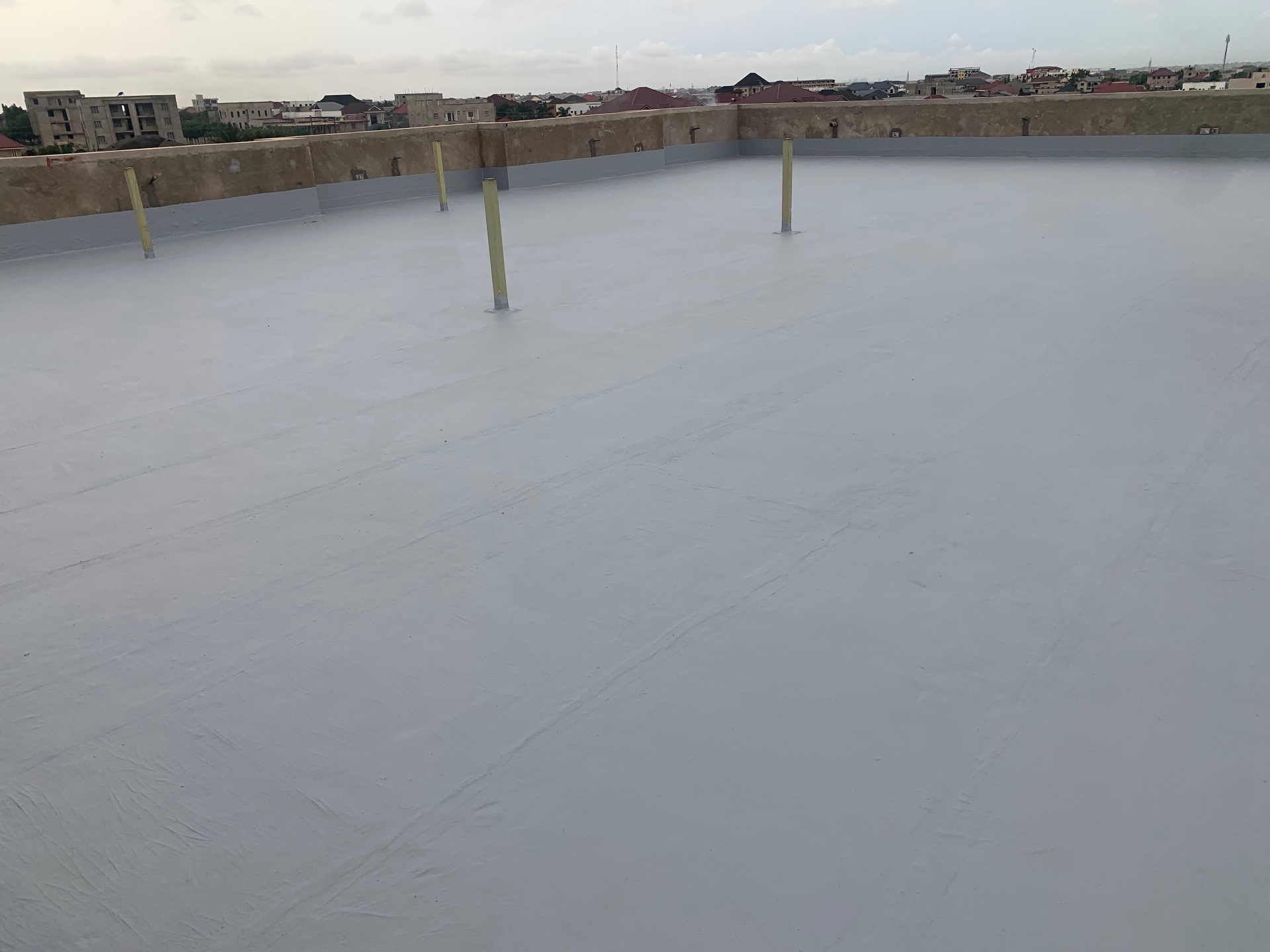 Waterproofed rooftop with sealed parapet upstands