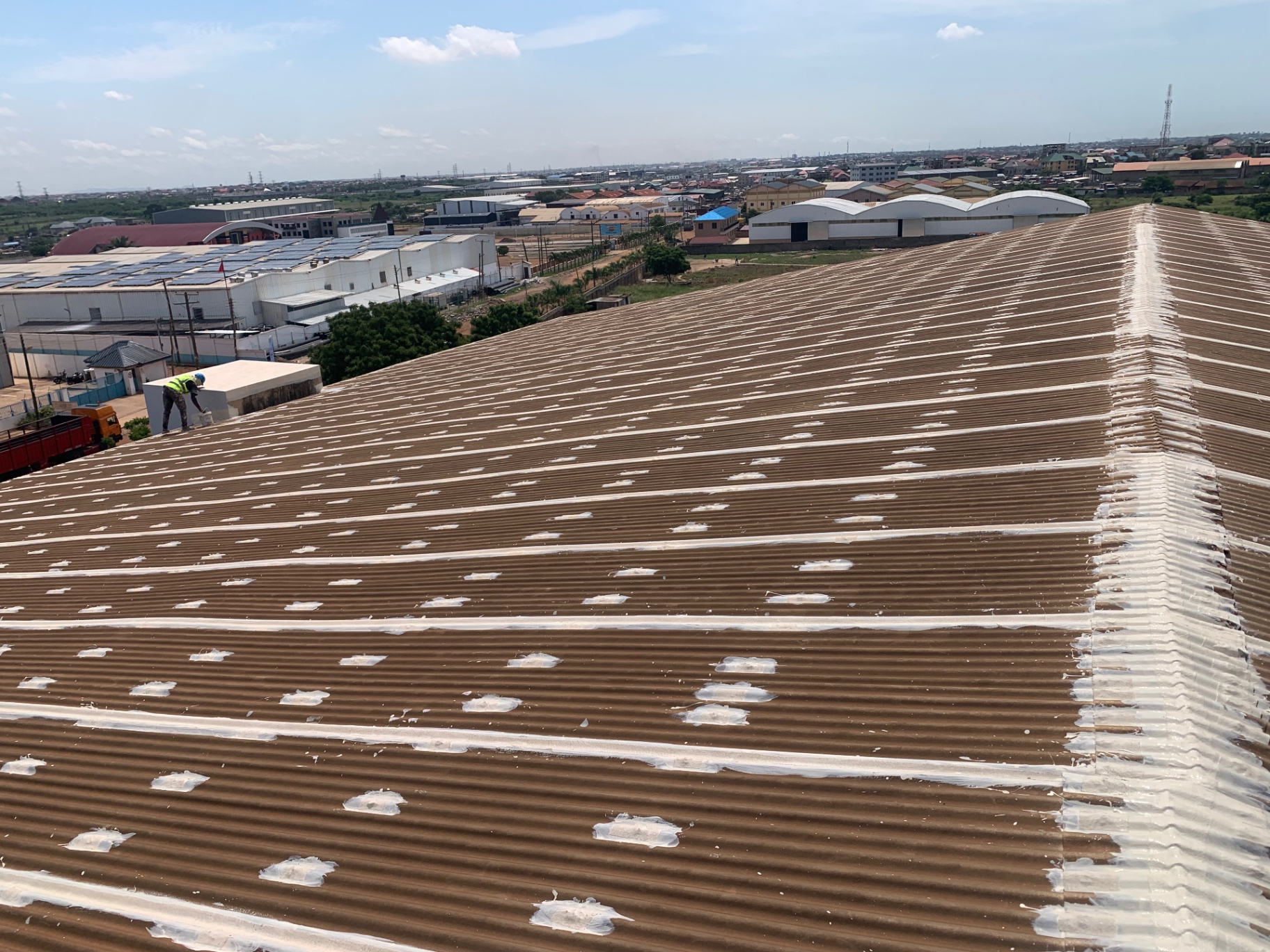 Large industrial metal roof with seam and fastener waterproofing