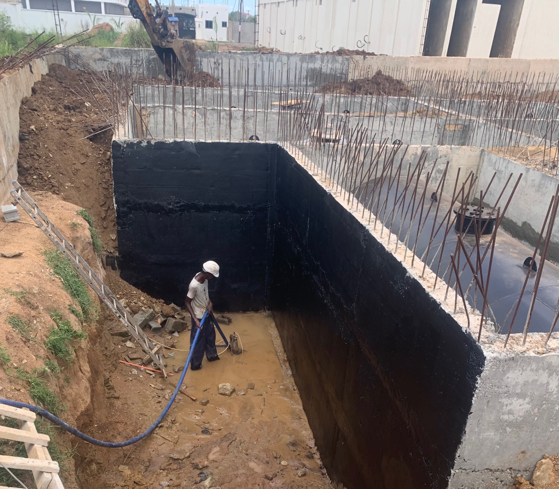Bituminous waterproofing applied to basement retaining wall