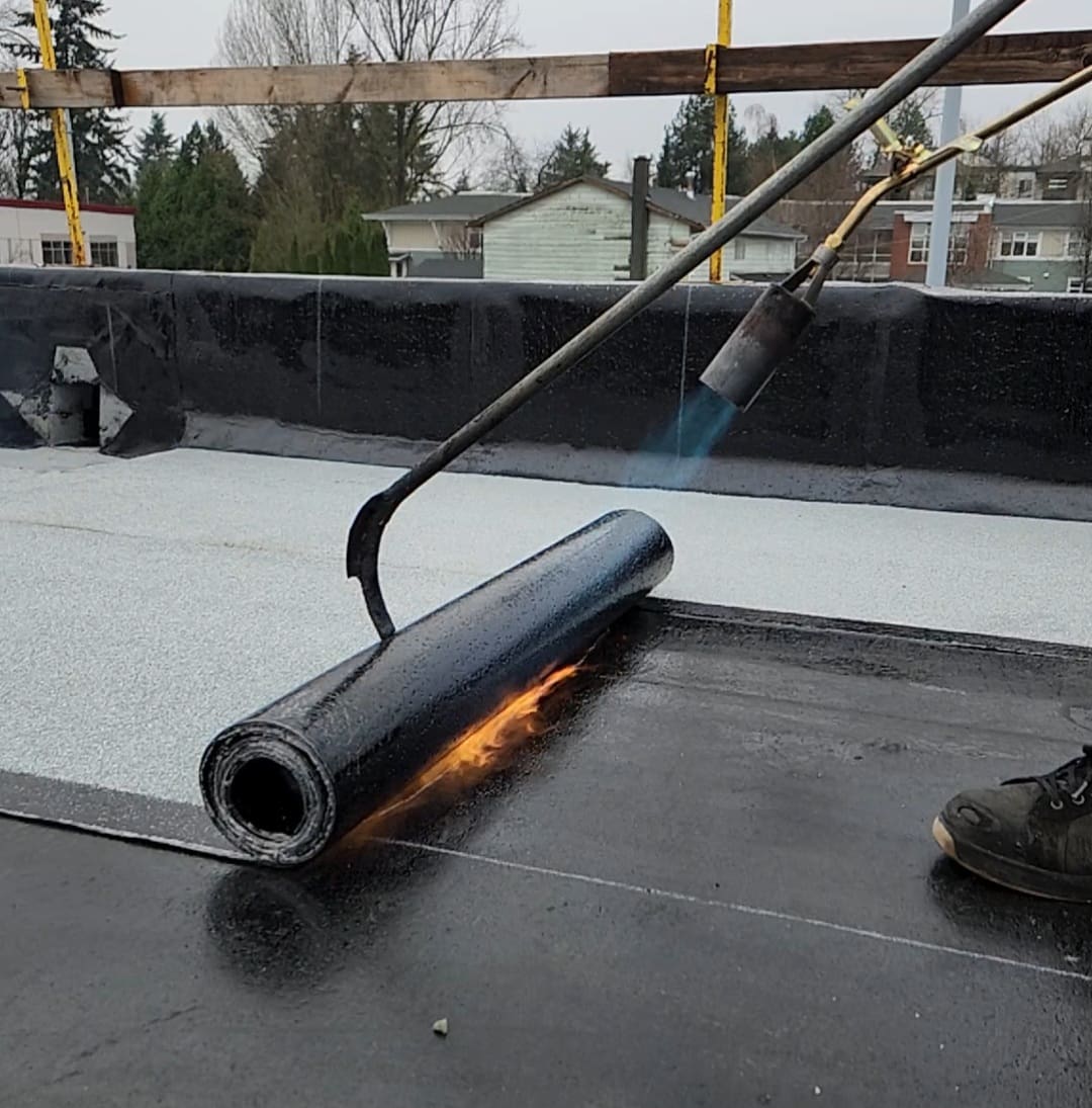 Bitumen membrane installation on commercial flat roof