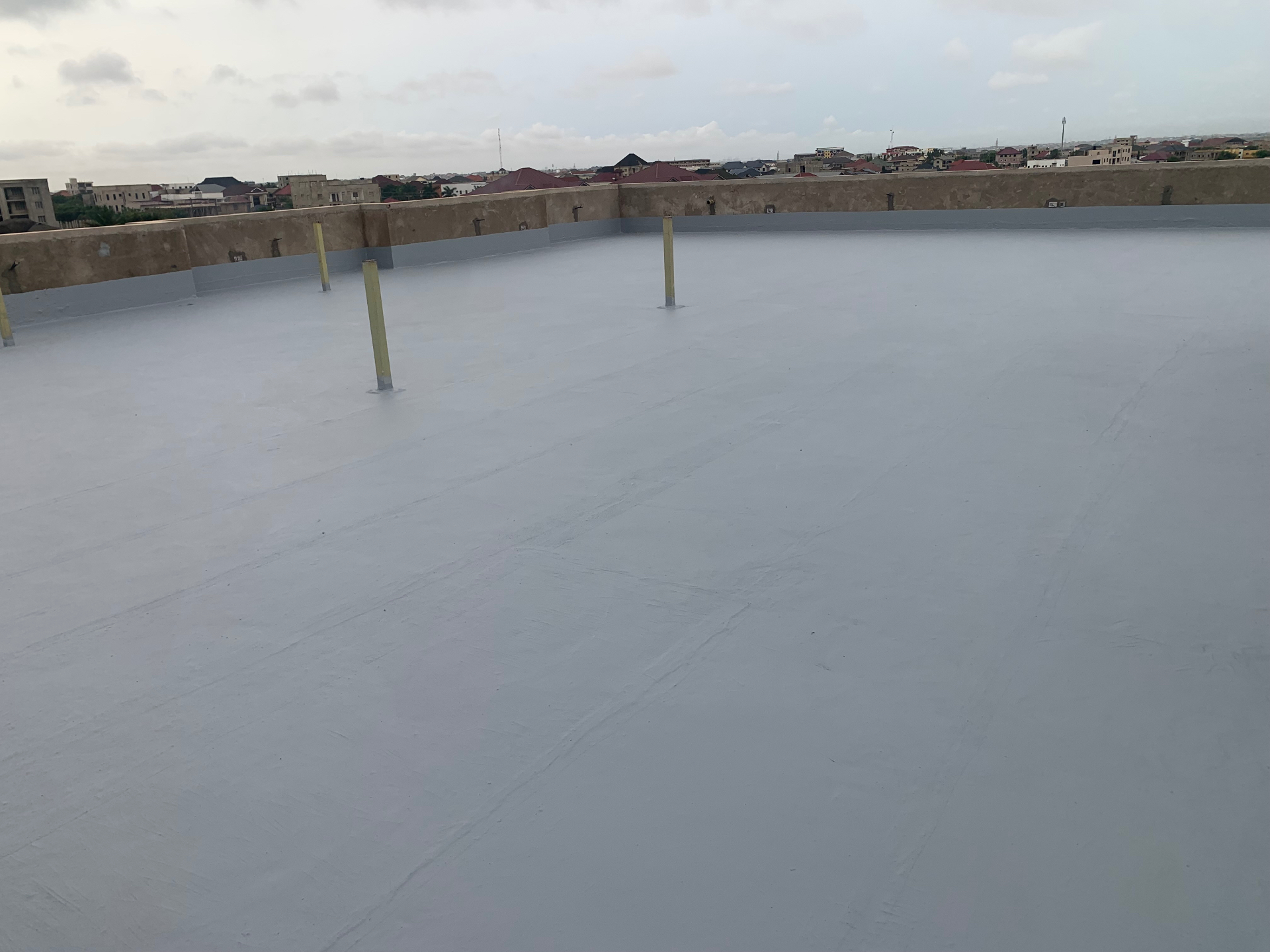 Wide-angle view of finished rooftop waterproofing coating
