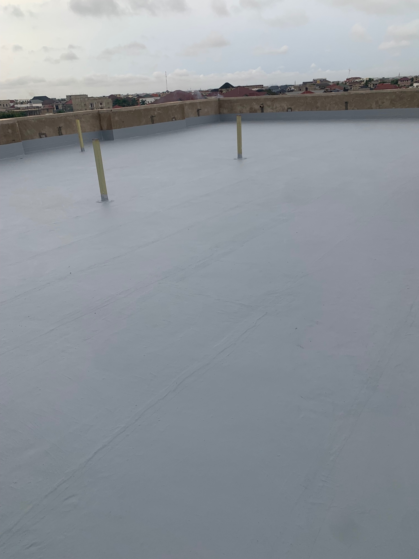 Rooftop liquid waterproofing membrane — completed deck, Accra